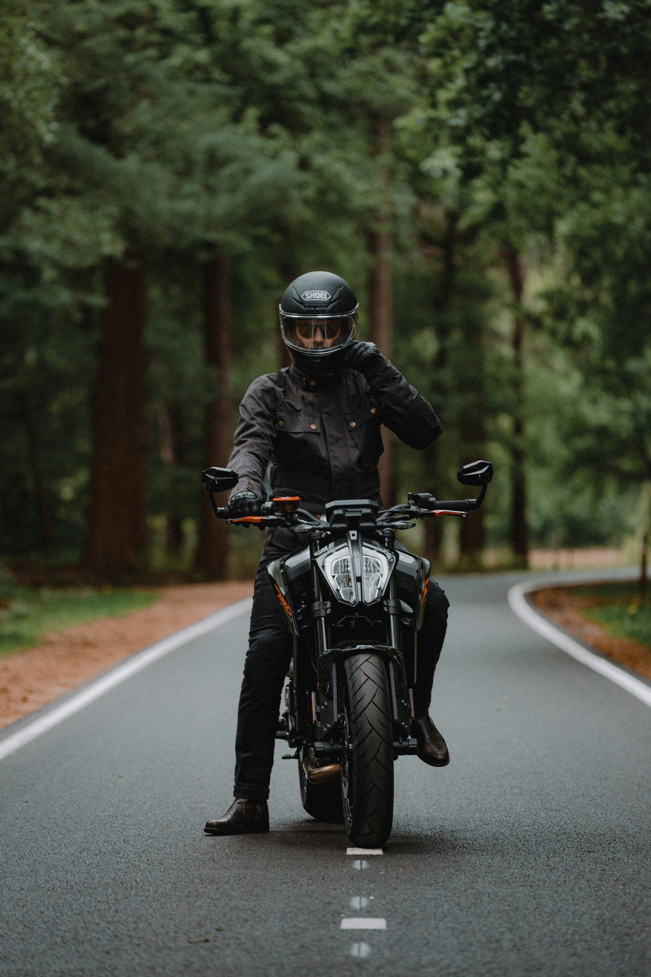 Rider on a motorcycle on a forest road